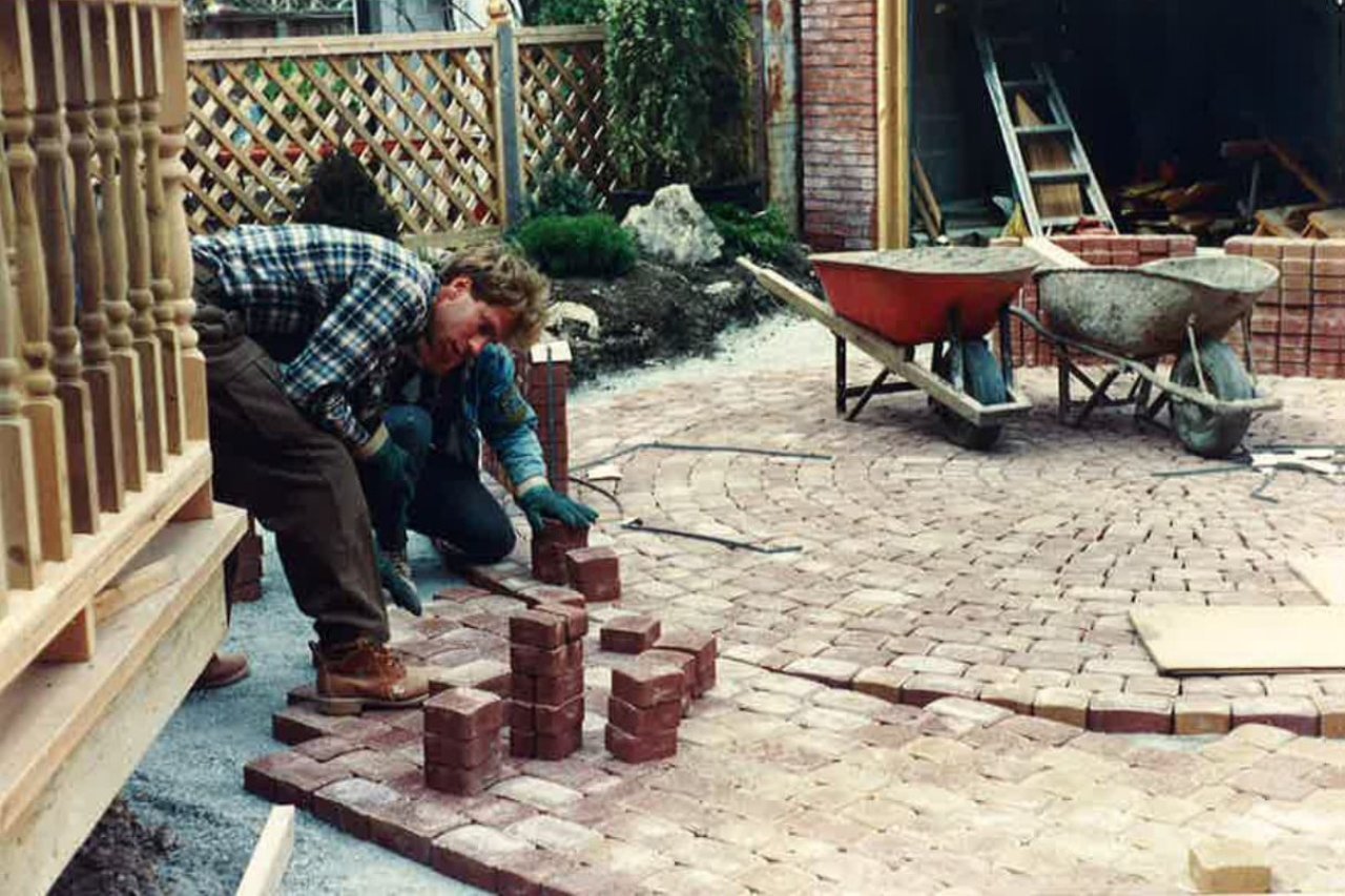 two men laying patio stones
